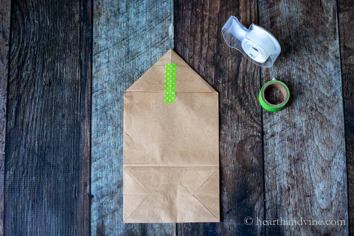 Brown paper bag with corners folder over and taped down with green washi tape.