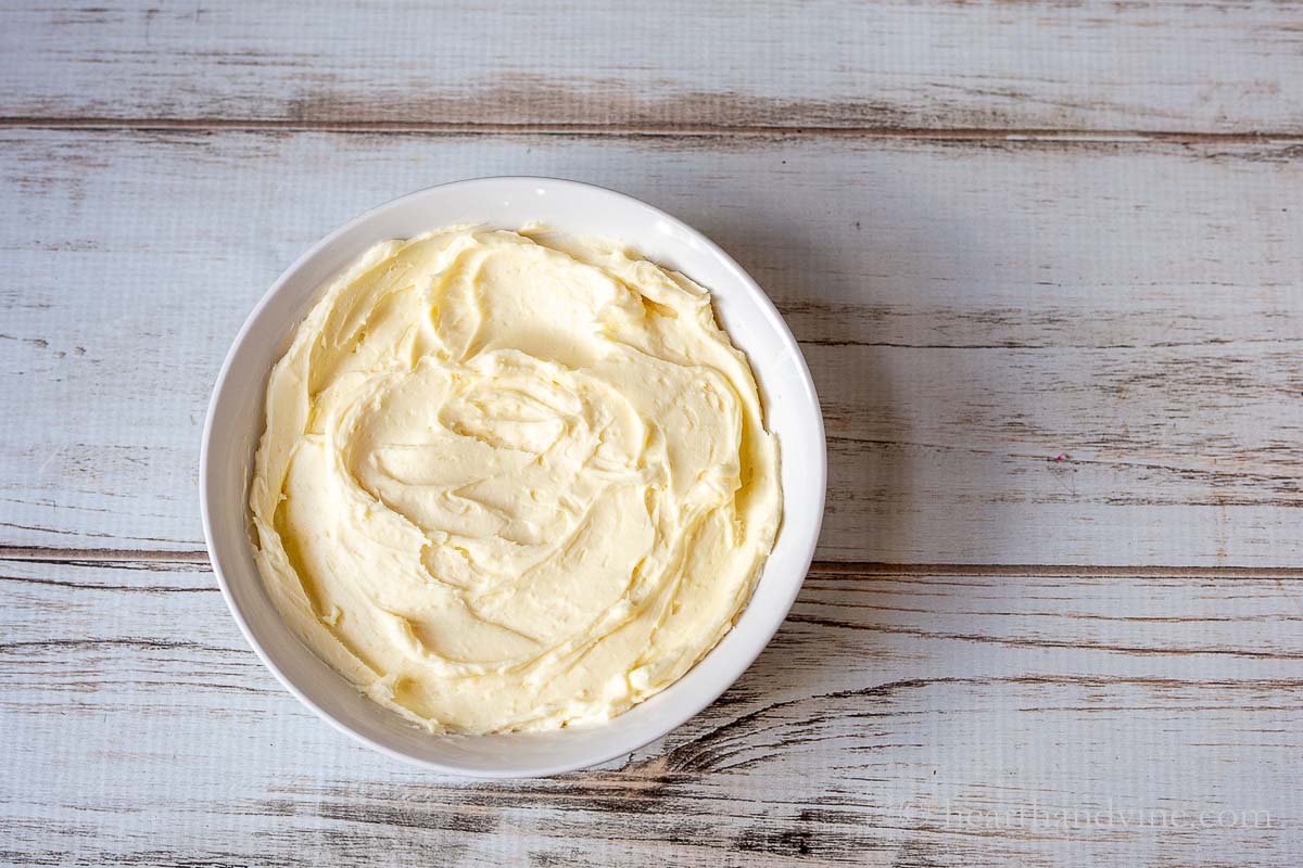 A white bowl with whipped brie cheese.