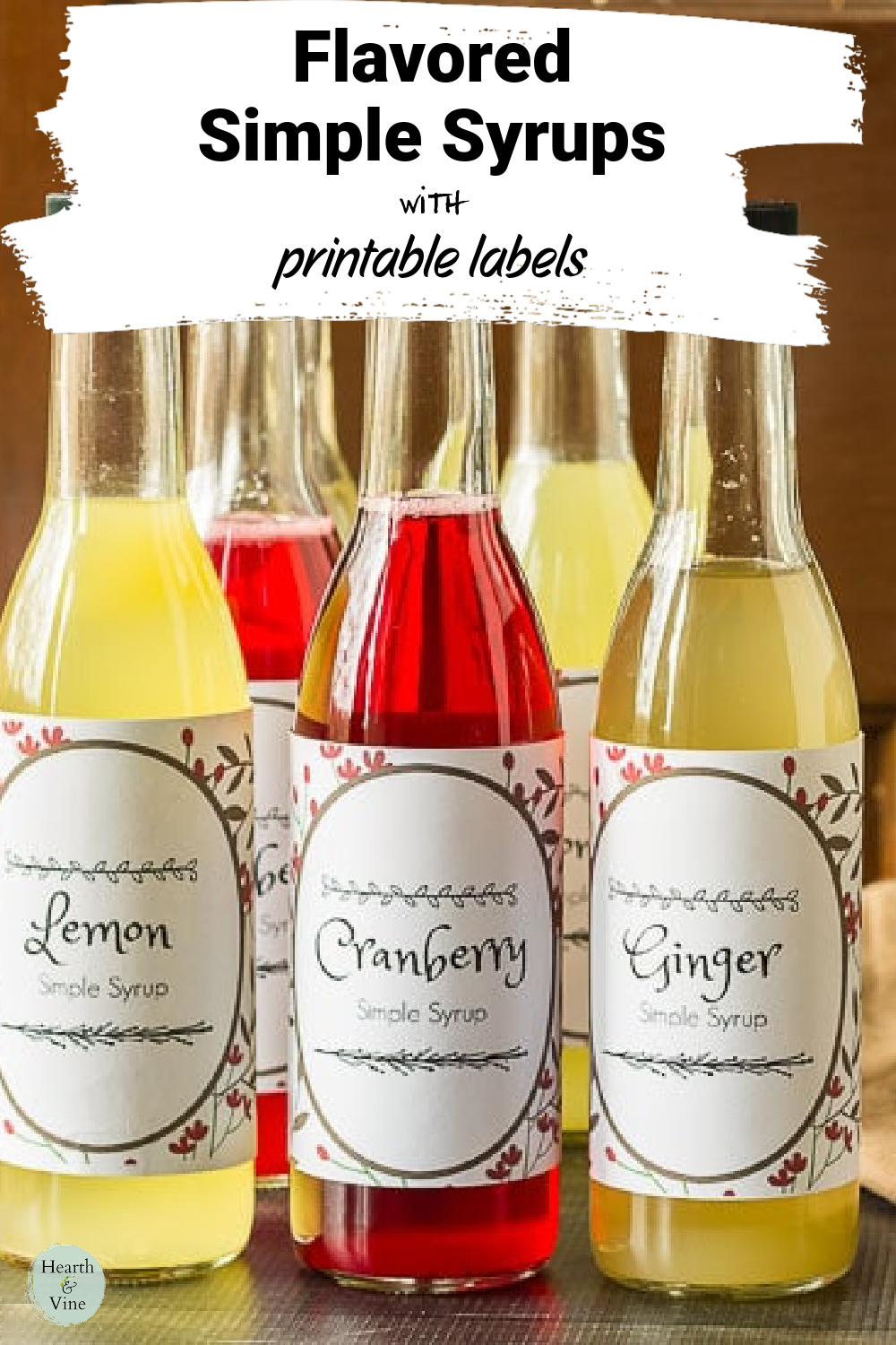 Three festive simple syrup bottles in lemon, cranberry and ginger.