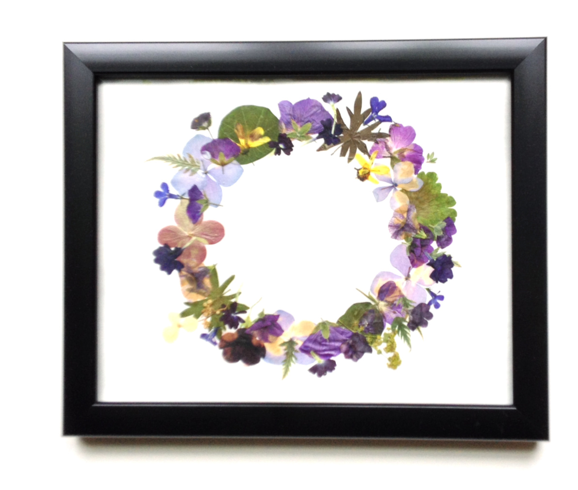 Pressed flowers into a wreath shape and framed.