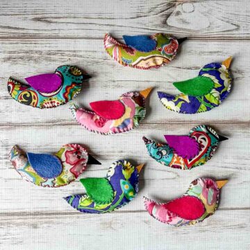 Eight colorful fabric birds.