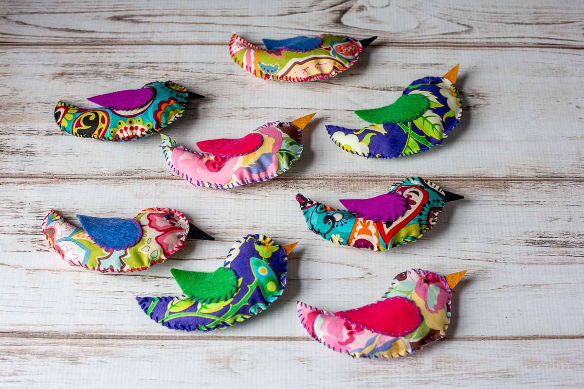 Eight colorful fabric birds. Two in each printed fabric.