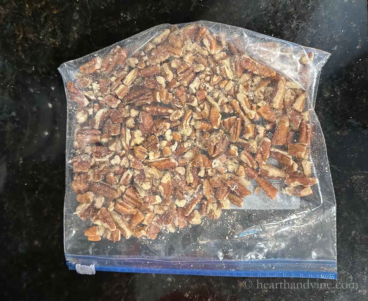 A plastic bag with pecan nuts inside.