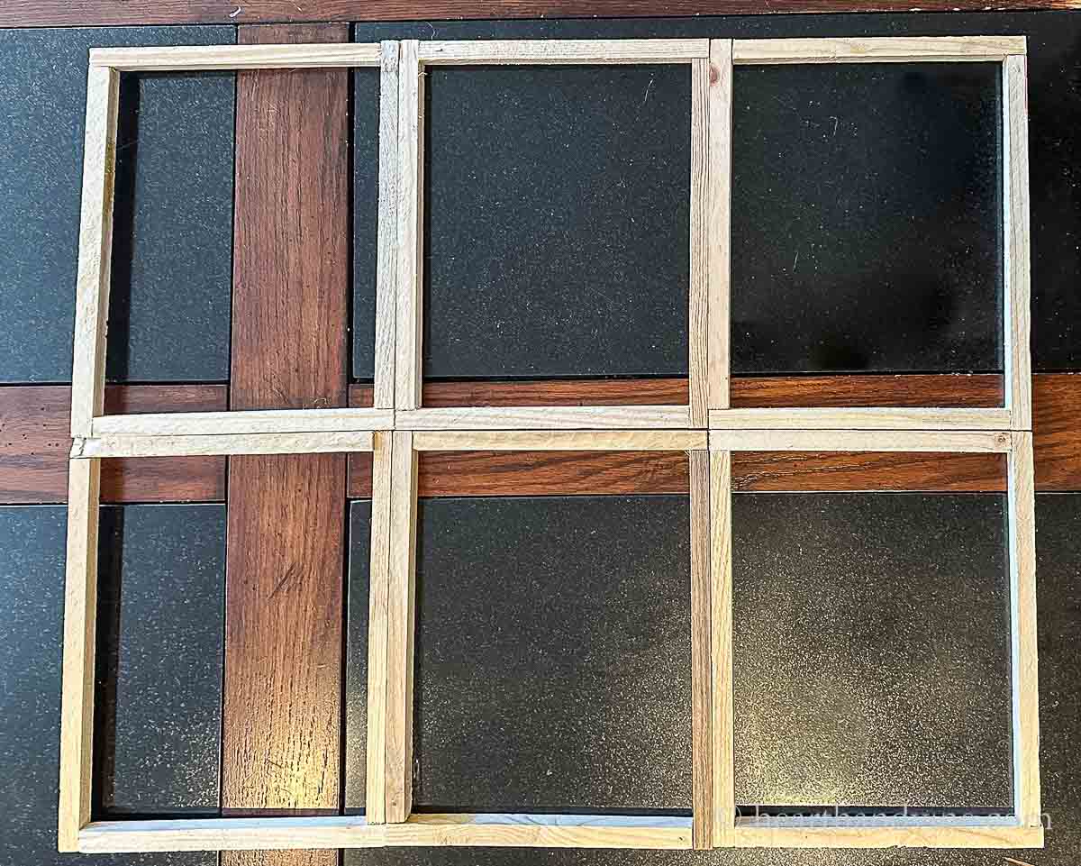 Six wood frames glued together to make a larger window frame. 