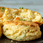 Close up of cheddar and chive biscuit broken in half.