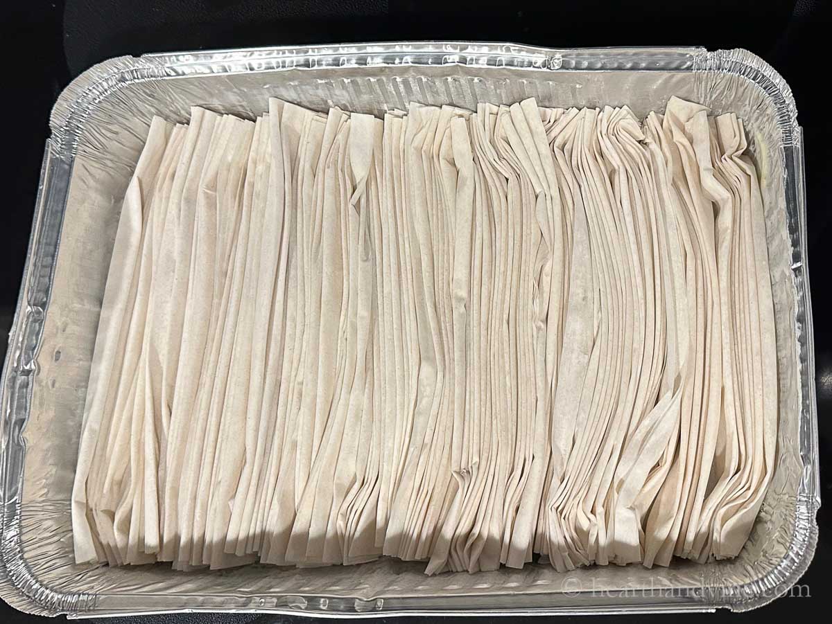 Folded phyllo sheets in a pan.