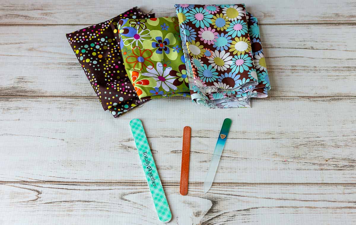 Three bright printed fabric above three different kinds of nail files.