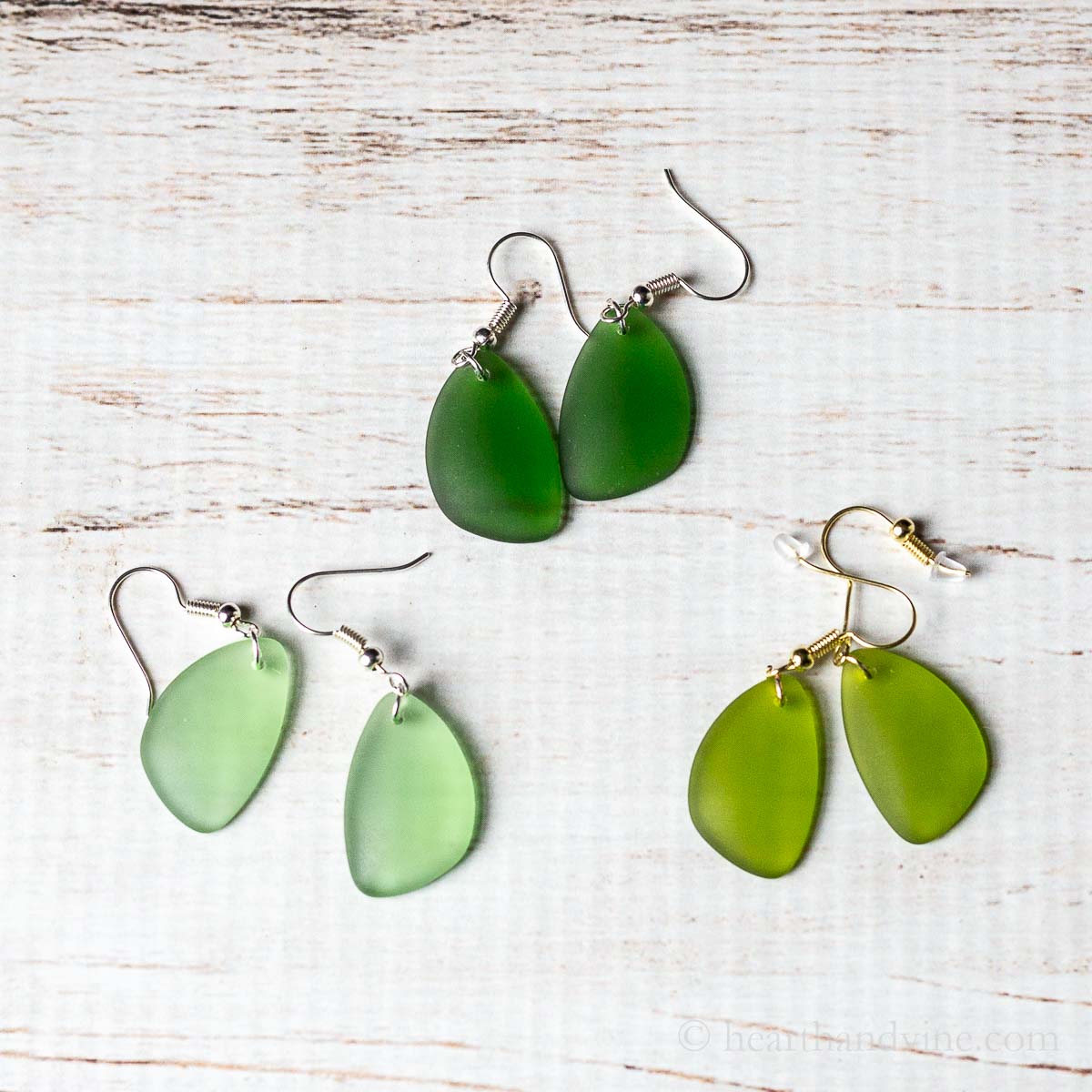Three pairs of sea glass earrings in shade of green.