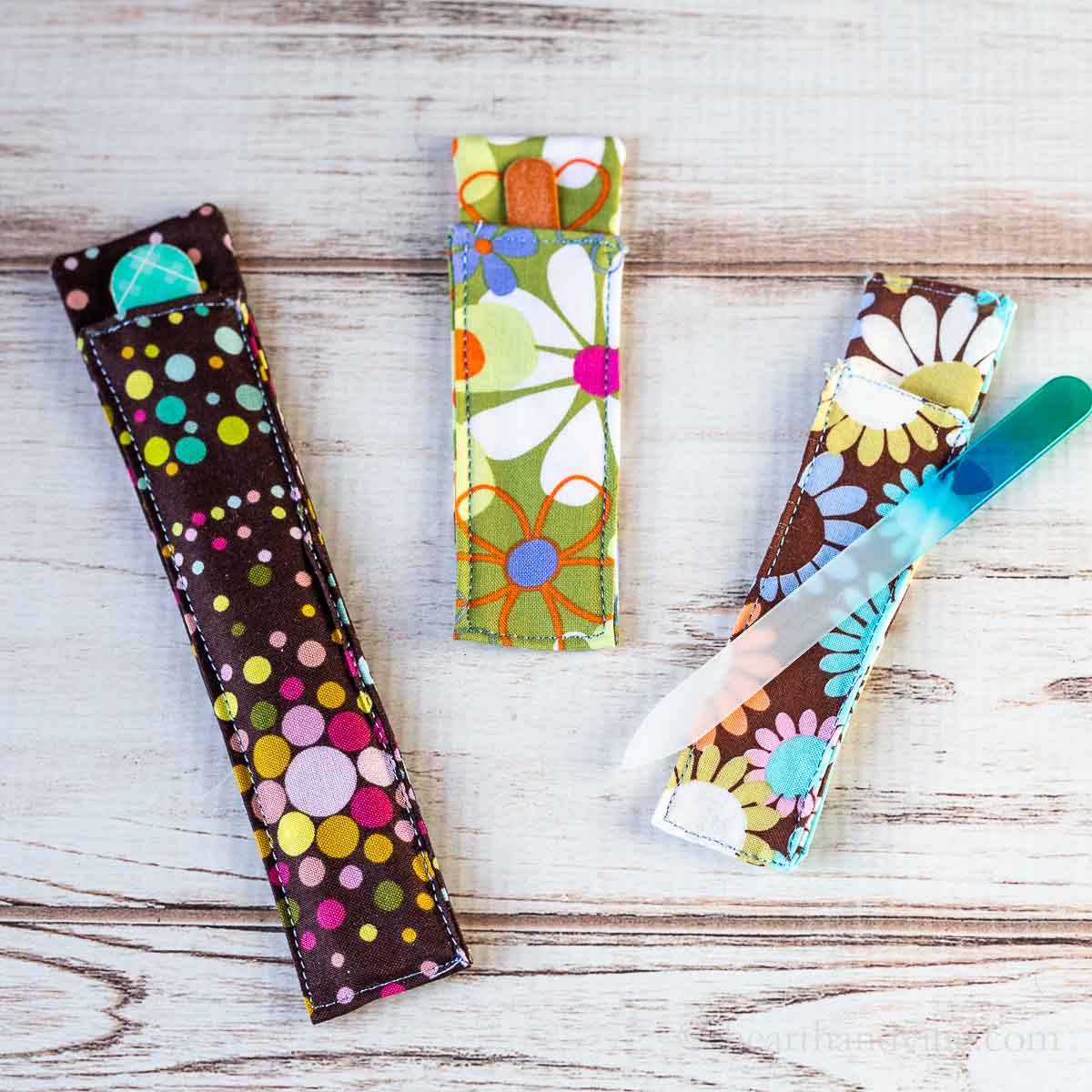 Three different sized nail file holders in three different printed fabric.