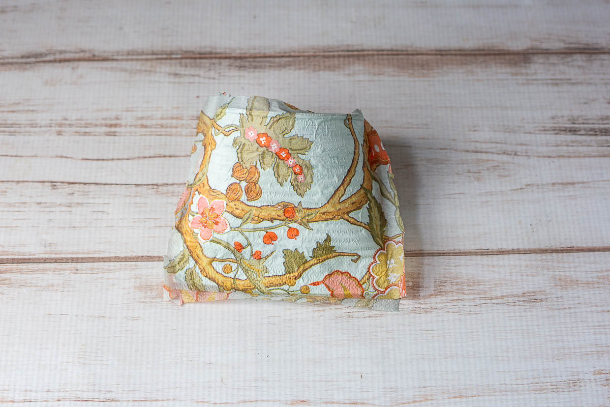 The decoupaged can with trimmed edges.