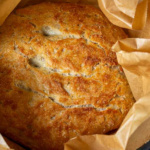 Loaf of bread in parchment in a Dutch Oven.