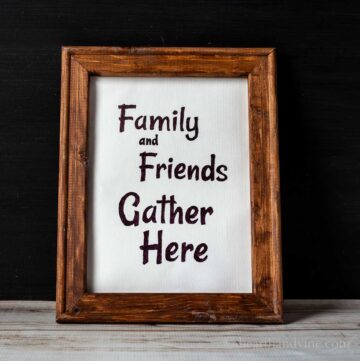 Rustic reverse canvas sign with the words Family and Friends Gather Here.