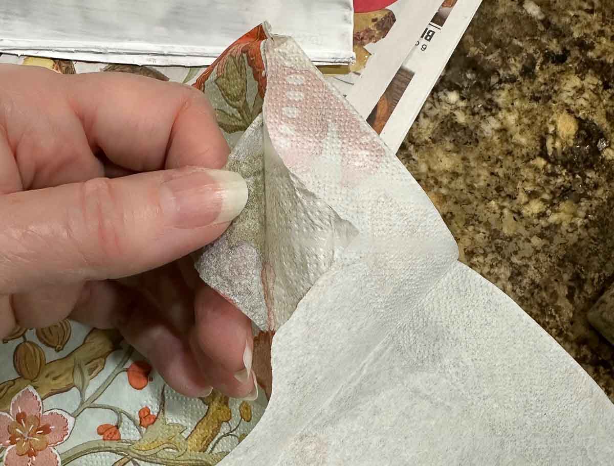 Tearing apart napkin backing.
