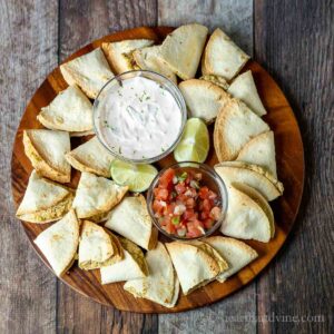 Round platter filled with mini chicken quesadillas, crema and pico de gilla