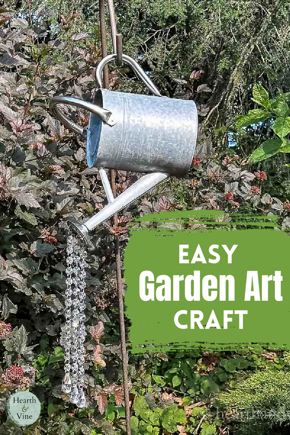 Metal watering can hung on a shepherd's hook in the garden pouring crystals.