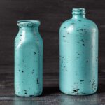 Two aqua distressed bottles.