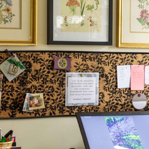 Cork board DIY bulletin board with notes hung horizontally on the wall.