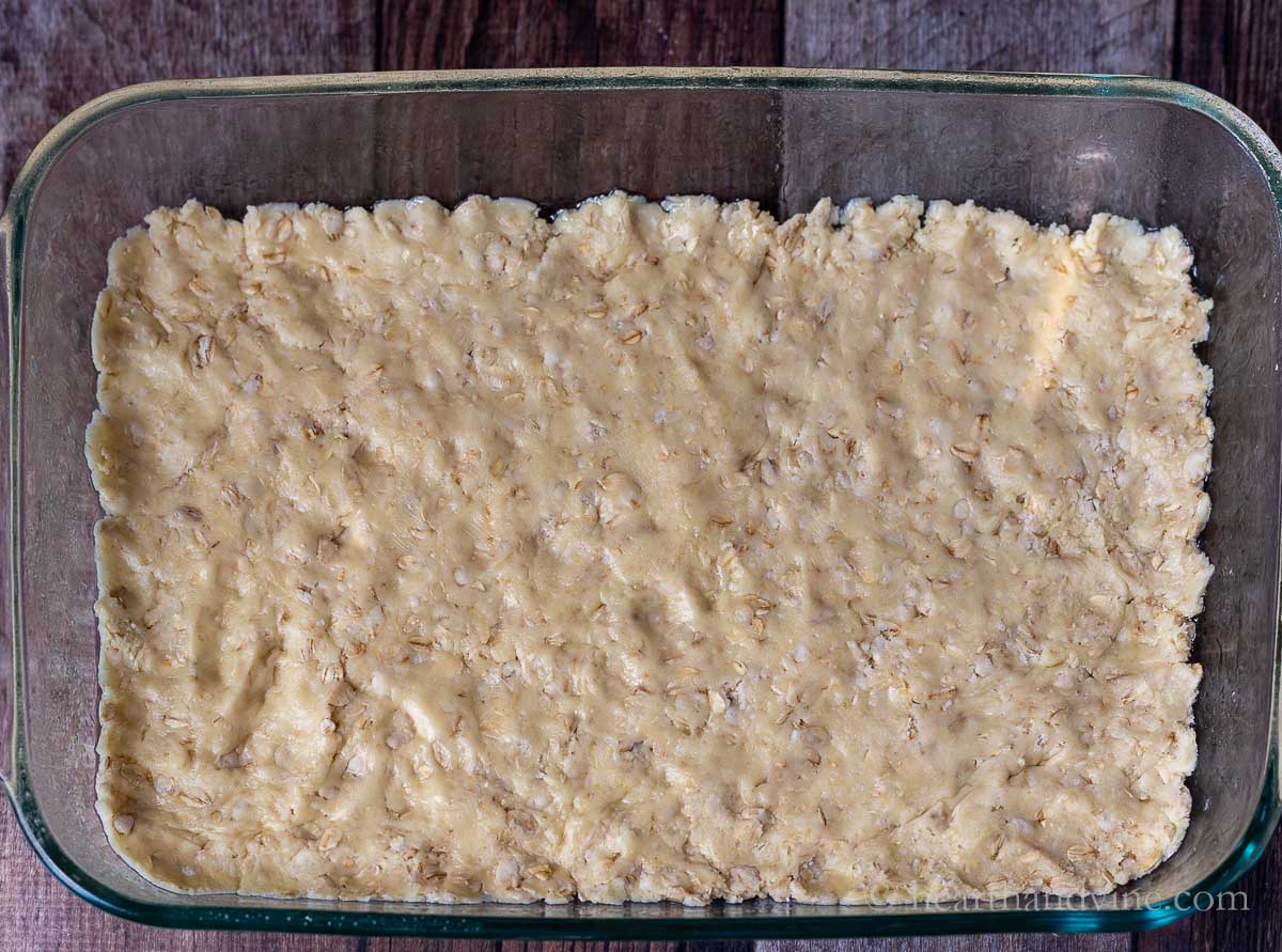 Plum Cobbler bars crust pressed into a 9 x 13 inch pan.