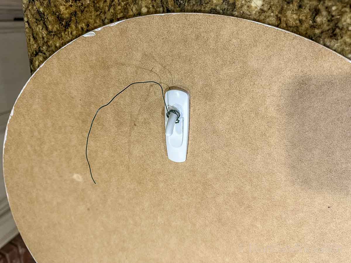 Command hook and wire on the back of the wooden round full moon.