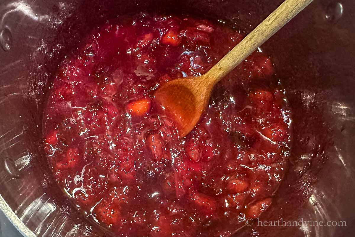 Thickened plum filling in a pot on the stove.
