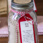 Single mason jar will with mug cake mix. A red and white instruction tag is tied on with red and white twine.