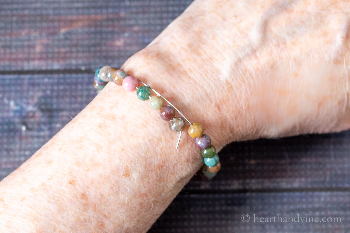 Beaded memory wire fitted on a wrist.