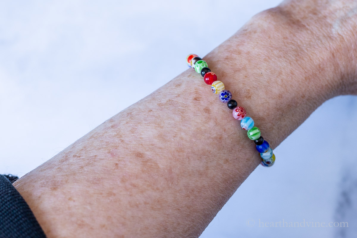 Completed colorful memory wire bracelet on a wrist.