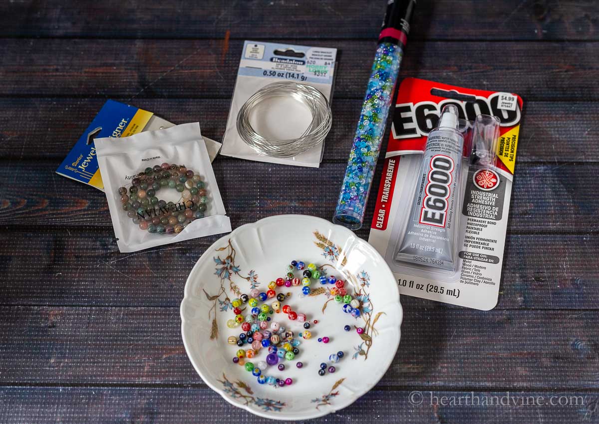 Supplies for memory wire bracelets including beads, glue, and wire.