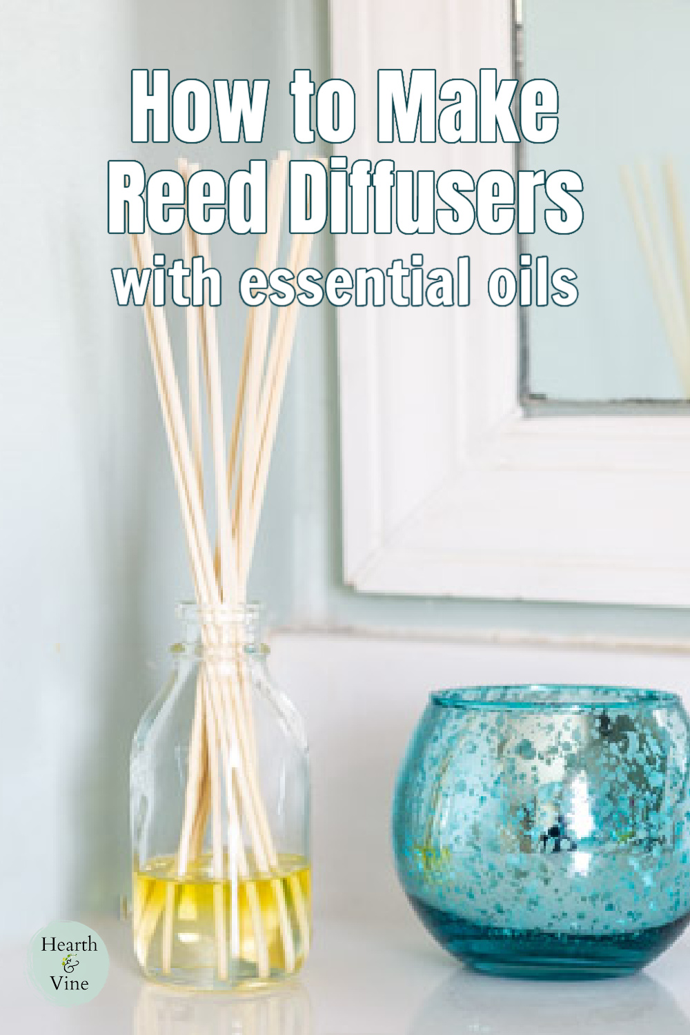 Homemade reed diffuser on a bathroom vanity next to an aqua bowl.