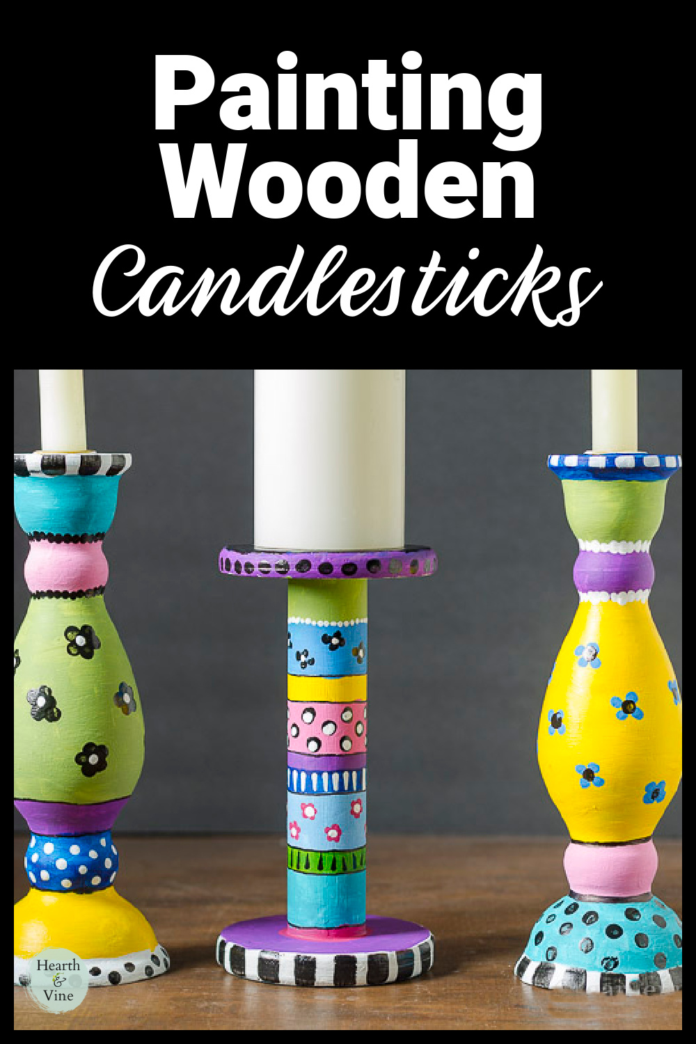Three brightly decorated wooden candlesticks with paint.