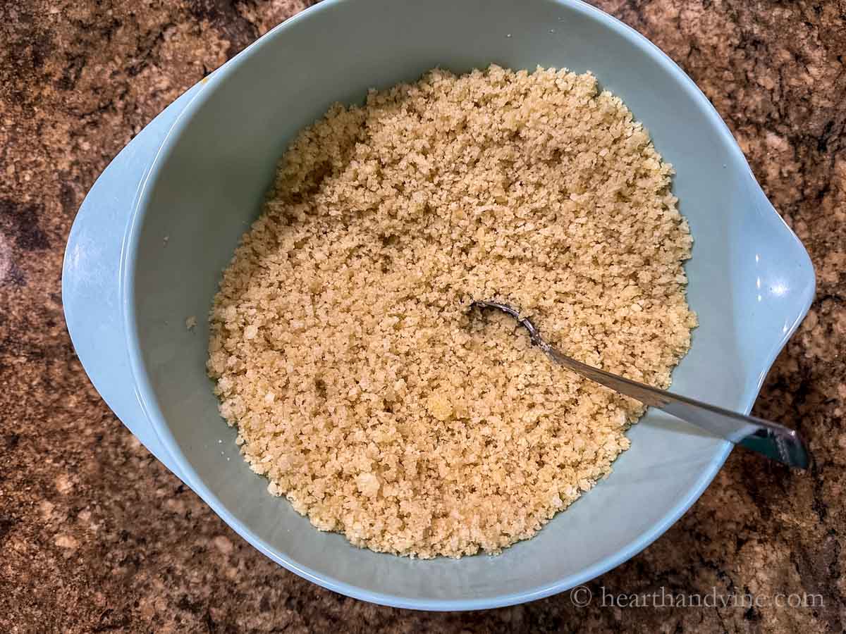 Mixing bowl with Panko breadcrumbs, butter, and parmesan cheese.