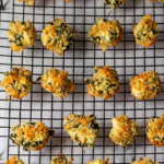 Spinach and artichoke dip bites on a cooling rack.