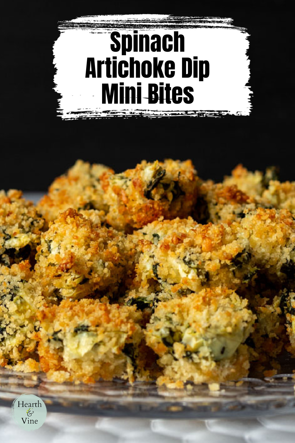 Spinach and artichoke dip bites on a glass platter.