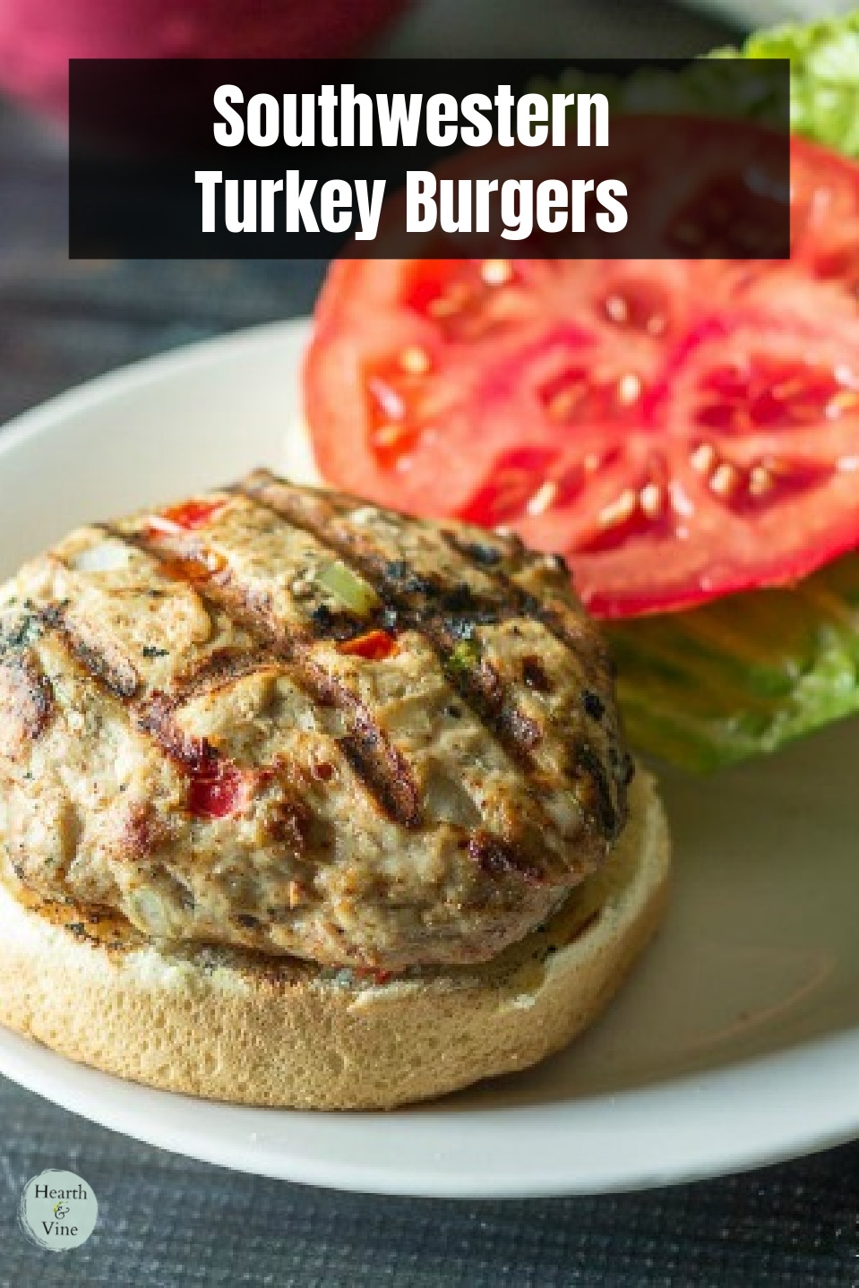 Open southwest turkey burger on a bun with lettuce and tomato.