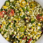 Close up aerial view of grilled corn avocado salad.
