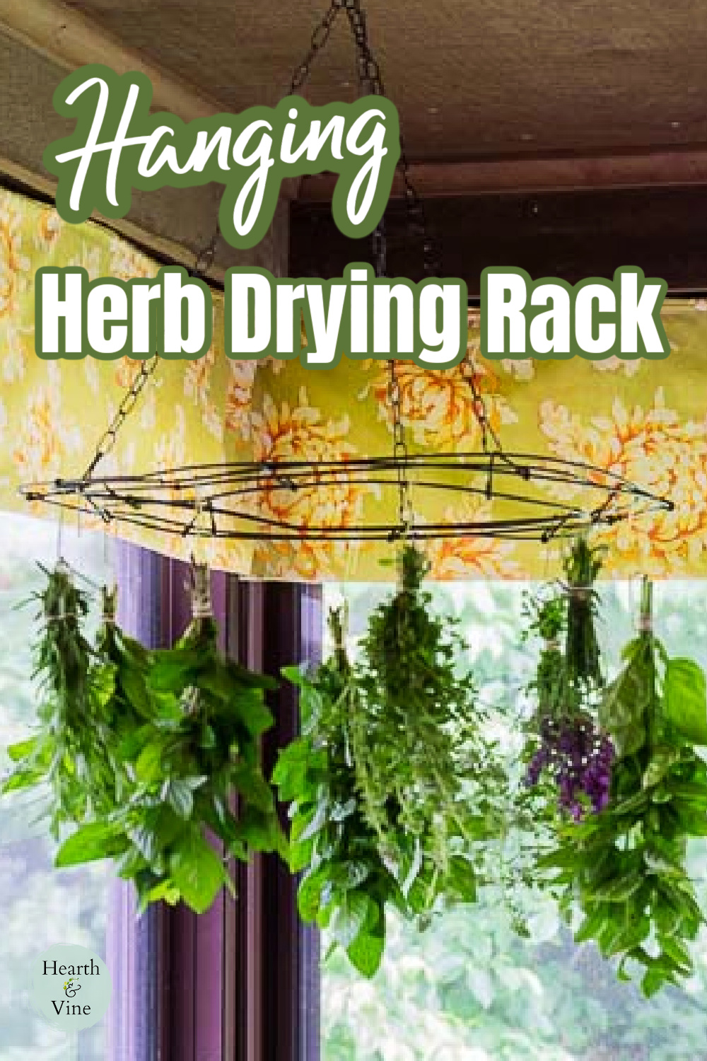 Bundles of herbs hanging from a DIY herbal drying rack from the ceiling of a porch.