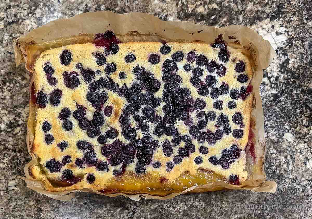 Lemon blueberry bars removed from the pan with the parchment paper.