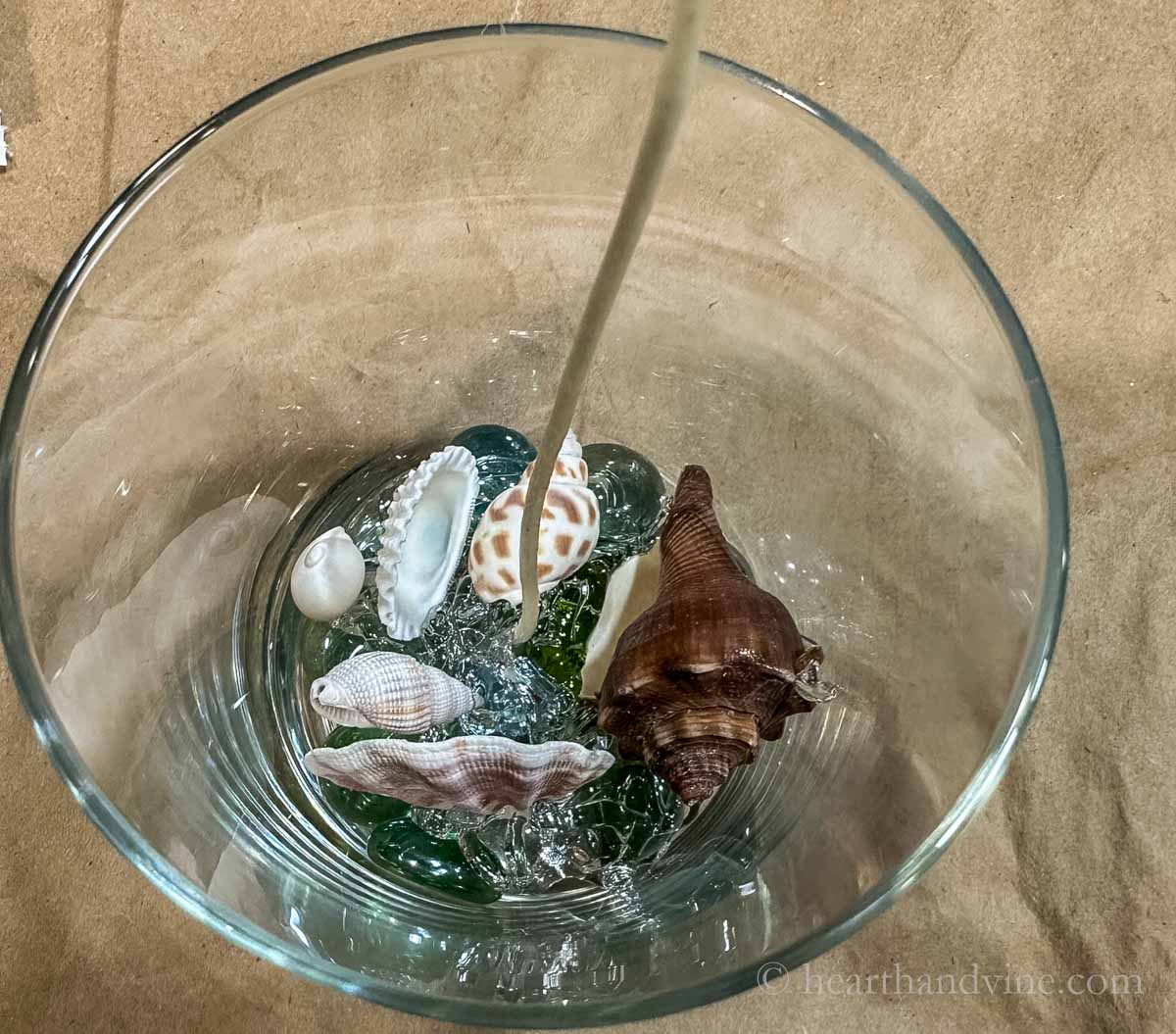 A little melted gel wax in the bottom of a glass the shells set in to hold them in place.