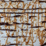 Center of a chocolate peanut butter poke cake in a sheet cake pan.