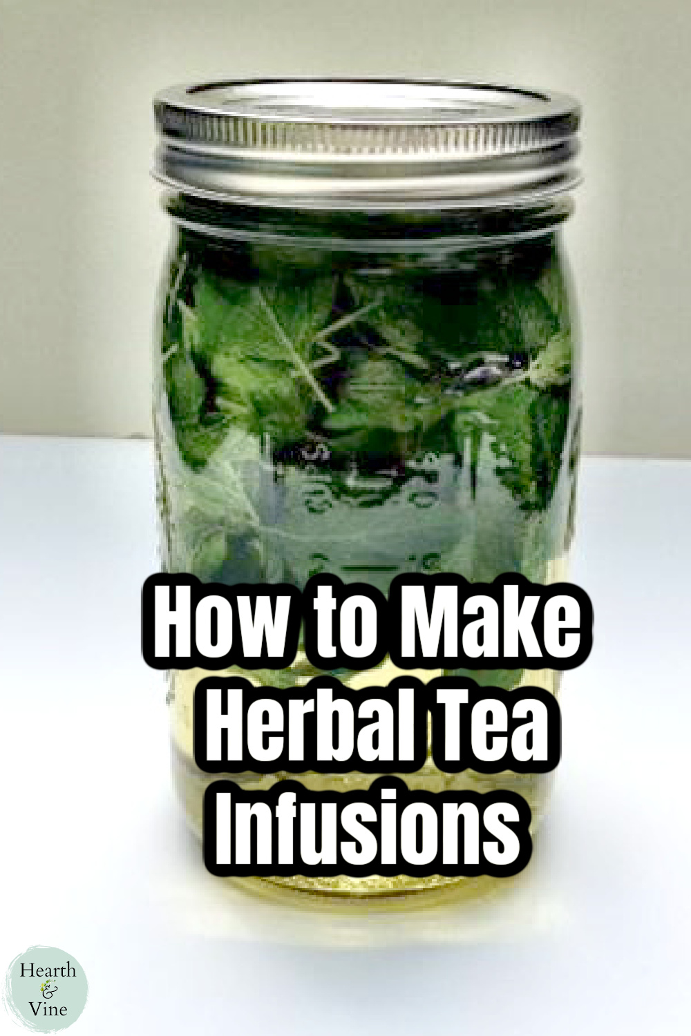 Mason jar filled with a mint tea infusion.