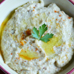Close up of a bowl of Lebanese Baba Ganoush with pita bread cut into triangles on the side.