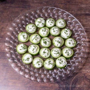 Cucumber bites on a clear round tray.