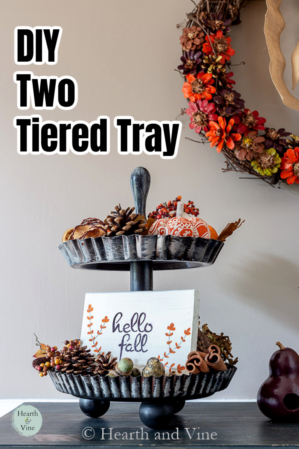 Brushed black two tiered tray with fall items including a hello fall sign, pine cones, berries, acorn and stuffed pumpkins.