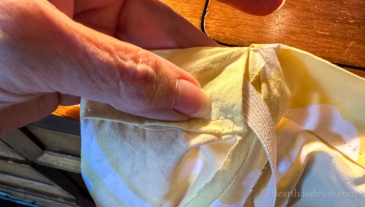 Threading the elastic through the waistband with safety pin.