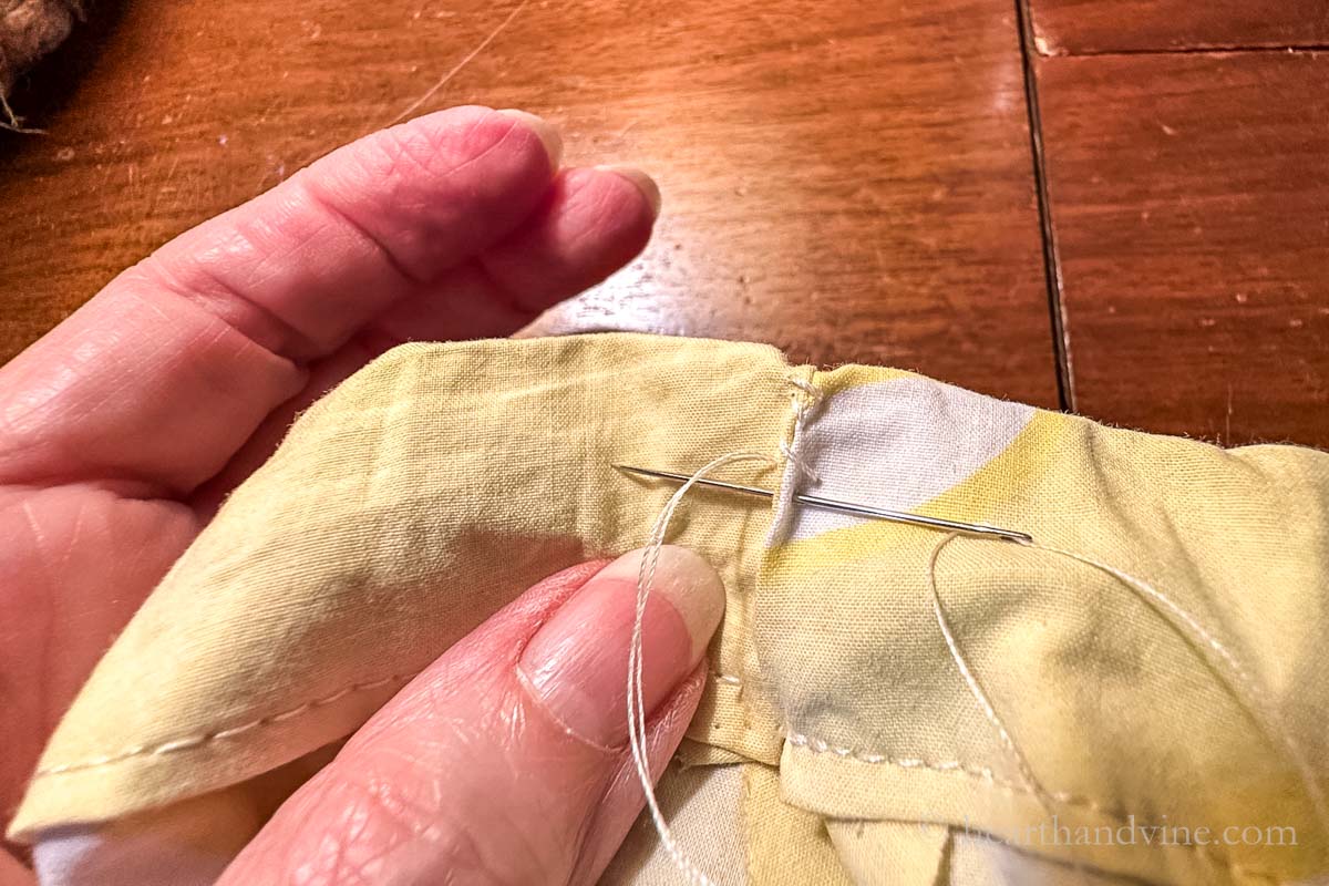 Hand sewing the waistband opening closed.