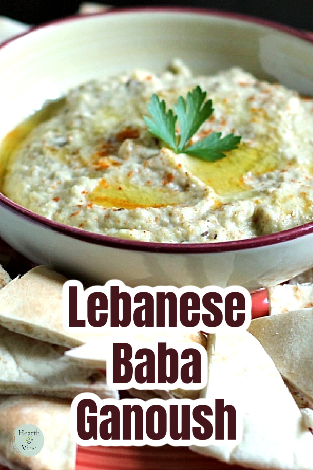 Bowl of baba ganoush with pita bread triangles around the sides.