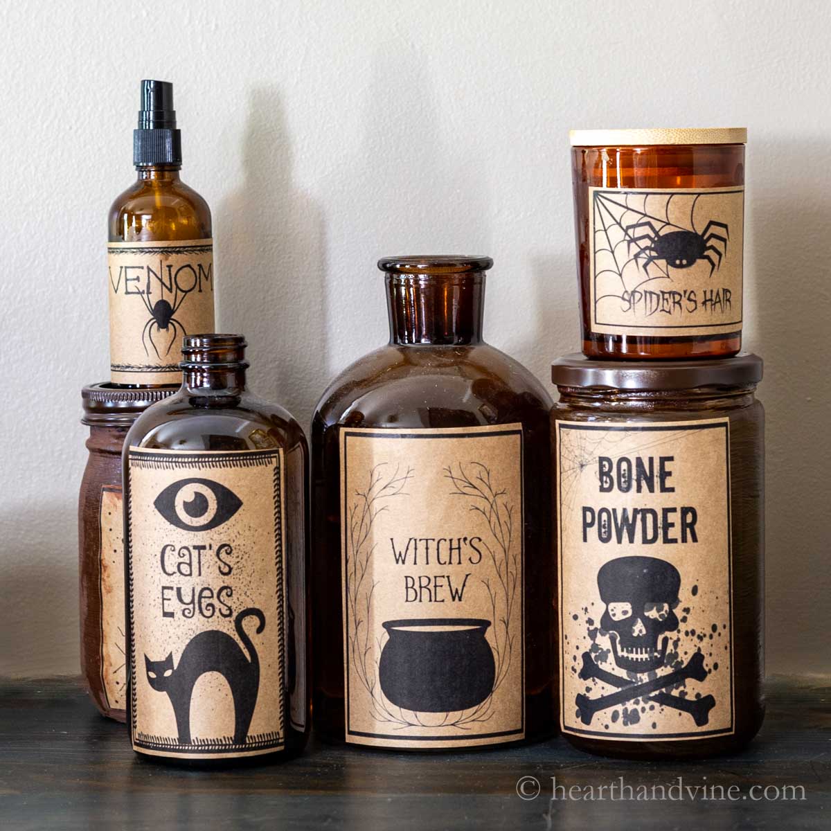 Serval amber Halloween potion bottles with spooky labels nested together.