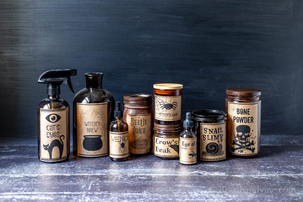 The completed jars and bottles lined up with the Halloween potion labels glued on.