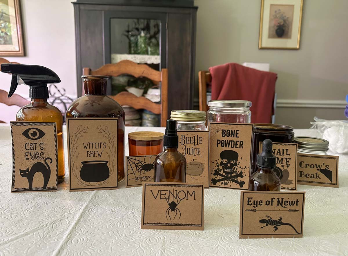 Halloween potion labels lined up against jars and bottles.