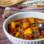 Bowl of beanless chili with fresh pumpkin chunks.